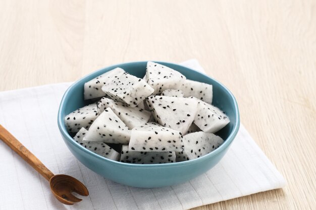 A bowl of fresh dragon fruit served on bowl on wooden background Breakfast fruit in the morning