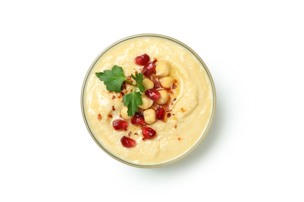 Bowl of fresh hummus isolated on white wall