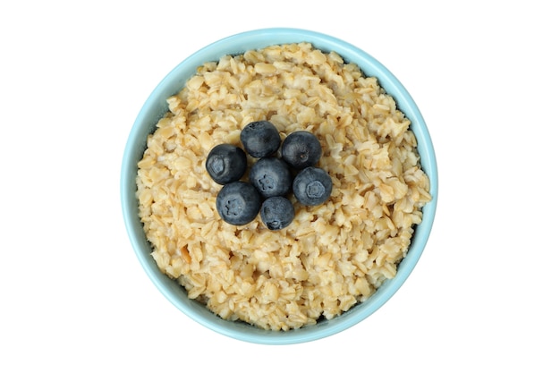 Bowl of fresh oatmeal isolated on white background