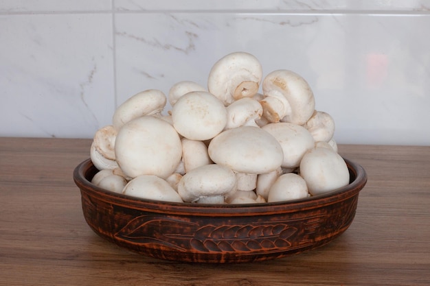 A bowl of fresh porcini mushrooms on the table