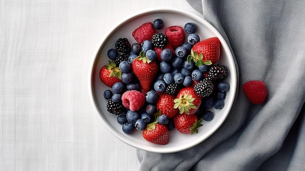 A bowl of fruit is on a blue napkin