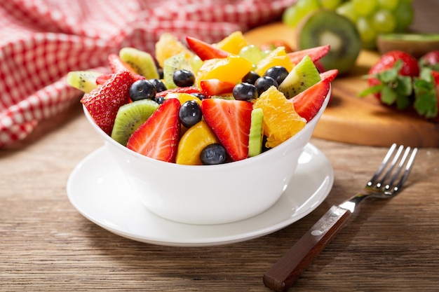 Bowl of fruit salad on a wooden table