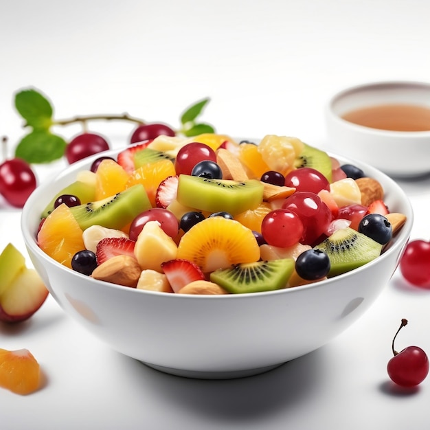 A bowl of fruit with a cup of tea in the background.