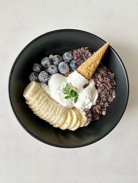 A bowl of fruit and yogurt with a cone on top