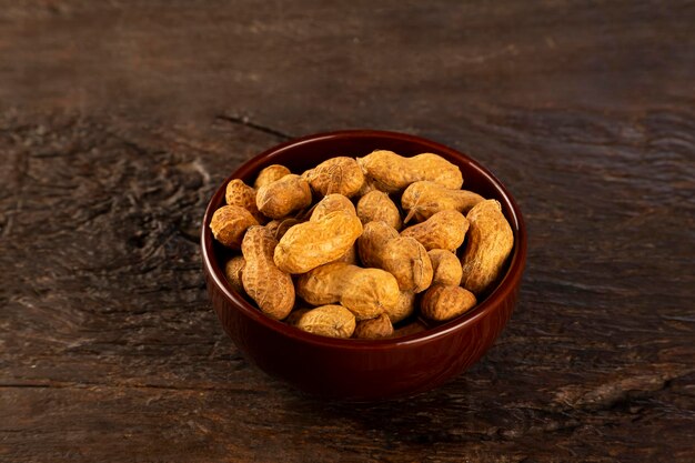 Bowl full of roasted peanuts.