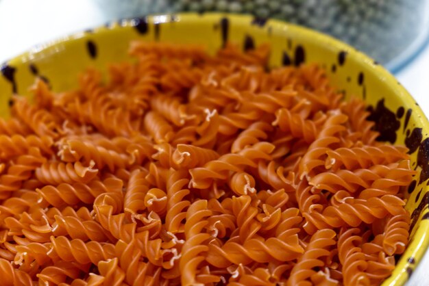 A bowl of fusilli flavored with pepper ready to cook