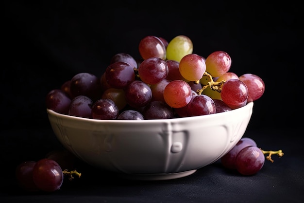 A bowl of grapes on a black background