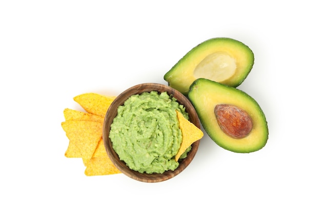 Bowl of guacamole, avocado and chips isolated on white background