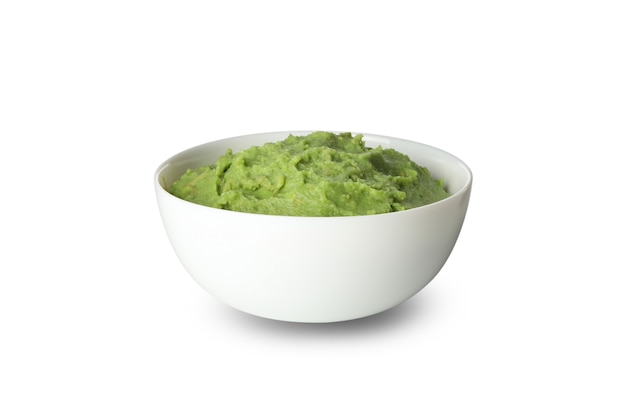 Bowl of guacamole isolated on white background