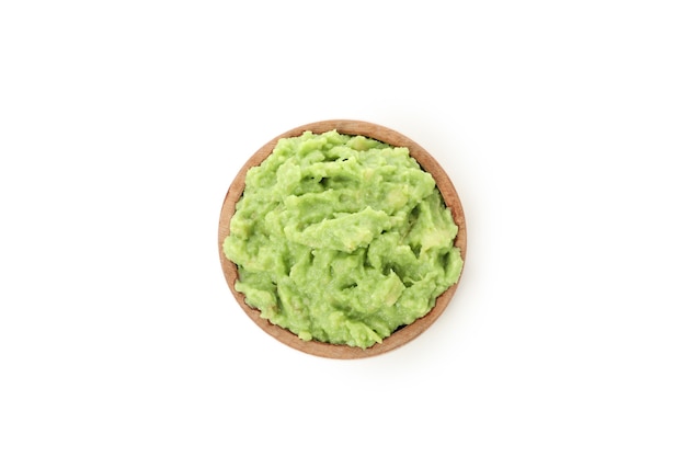 Bowl of guacamole isolated on white background