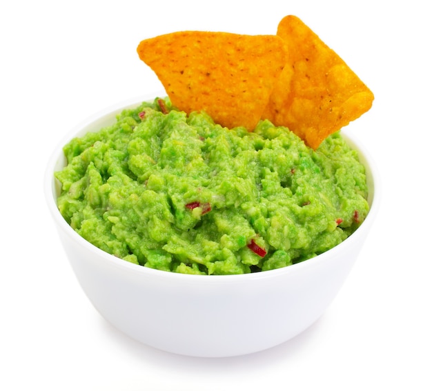 Bowl of guacamole with nachos isolated on white background