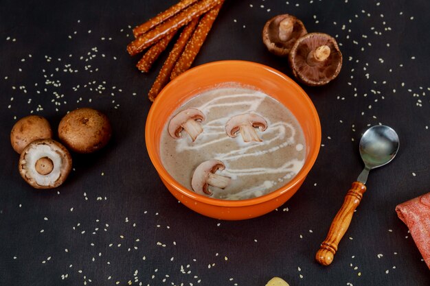 Bowl of Homemade with delicious mushroom soup on wooden table