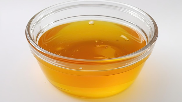 A bowl of honey is shown on a table.