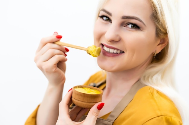 Bowl of honey on white background. Symbol of healthy living and natural medicine. Aromatic and tasty. Top view