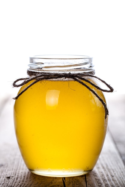 Bowl of honey on wooden table. Symbol of healthy living and natural medicine.