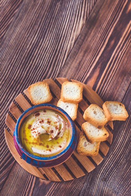 Bowl of hummus with toasts