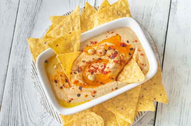 Bowl of hummus on the wooden table