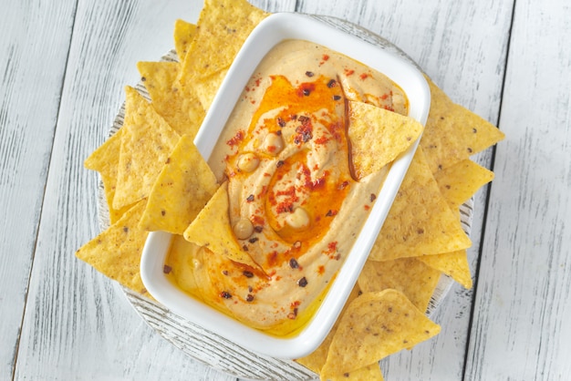 Bowl of hummus on the wooden table