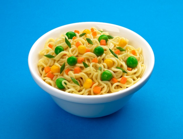 Bowl of instant noodles isolated on blue