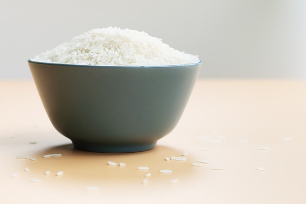 Bowl of jasmine white rice on yellow backgrounds