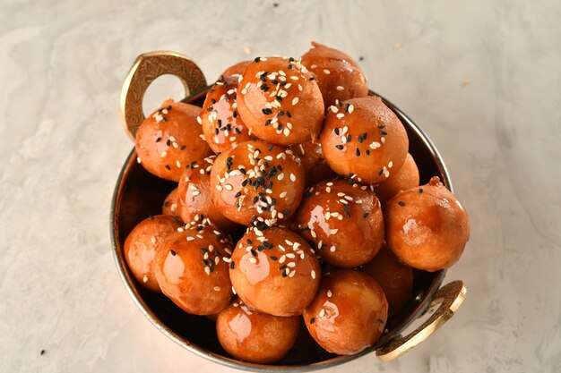 A bowl of korean meatballs with sesame seeds on top