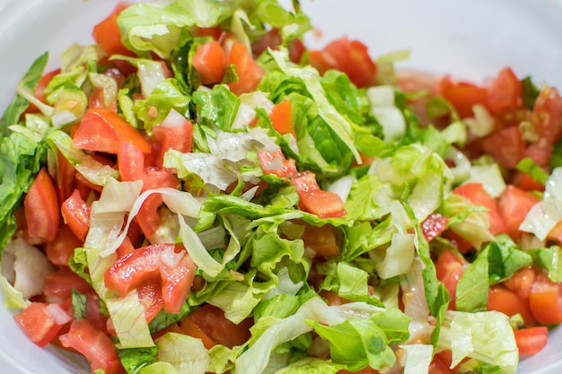 A bowl of lettuce, tomato, and lettuce.