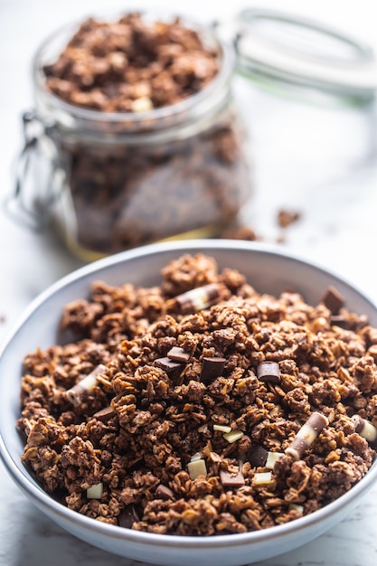 Bowl of muesli with dark and milk cocolate pieces - closeup.