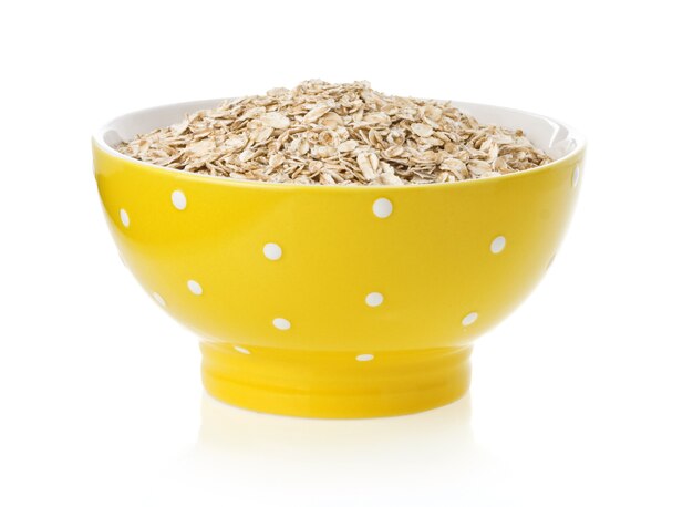 Bowl of oat flake isolated on white surface