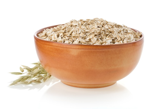 Bowl of oat flake isolated on white surface