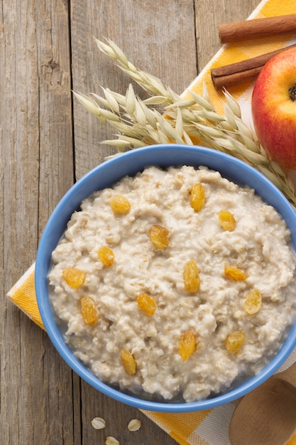 Bowl of oatmeal on wood surface