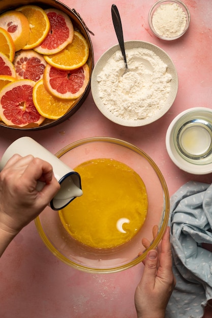 A bowl of oranges, lemon, and grapefruit mixture with a bowl of orange zest.