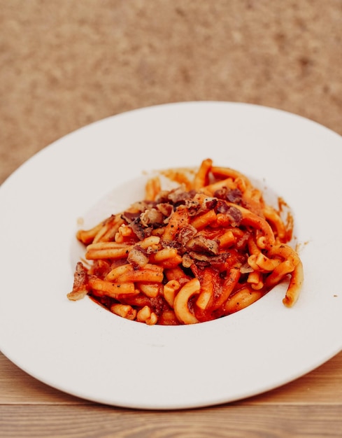 A bowl of pasta with meat sauce and cheese