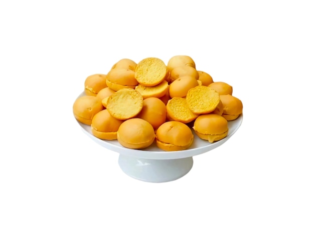 A bowl and a pile of pastries on a white background