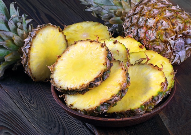 a bowl of pineapples on a wooden table