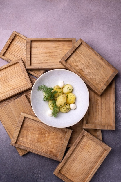 A bowl of potatoes with dill on top