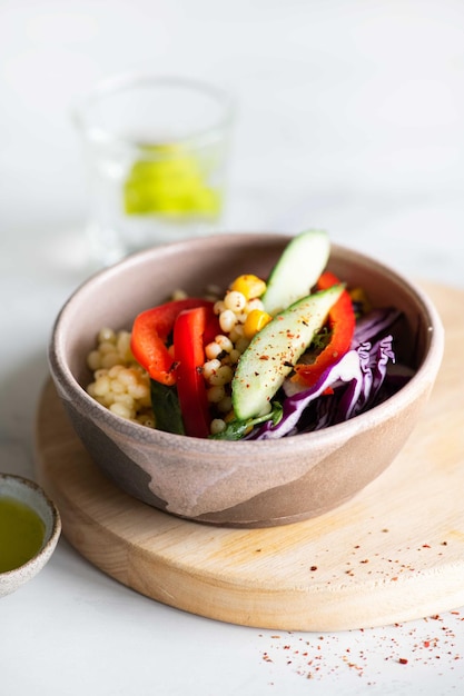 Photo a bowl of quinoa with a side of corn.