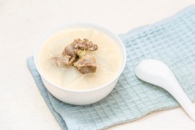 A bowl of radish stewed mutton soup is placed on the dining table