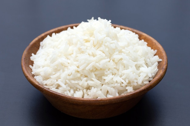 Bowl of rice on dark background.