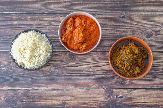 Bowl of rice served with Ofada and Pepper tomato stew