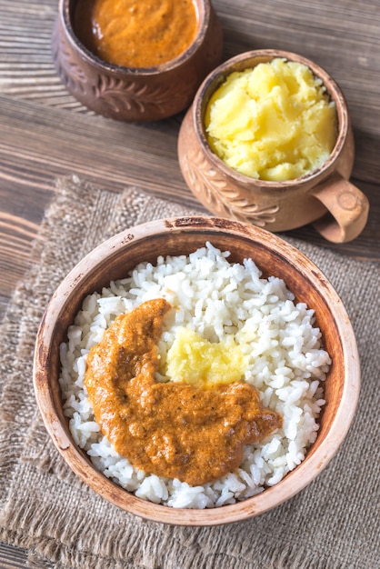 Bowl of rice with Indian butter sauce and Ghee clarified butter