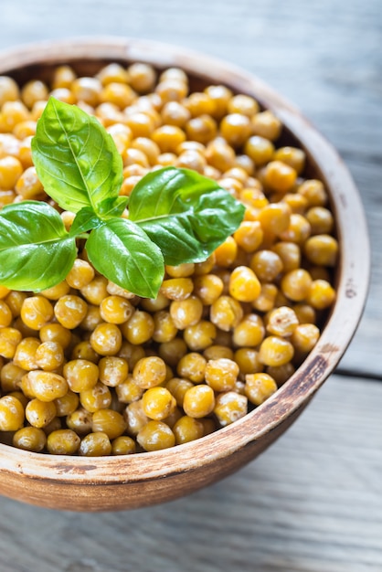 Bowl of roasted chickpeas on the wooden table