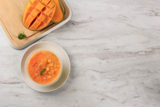 A Bowl of Sagoo Mango (Mango Lolo) or Mango Pudding, Hongkong Mango Dessert made from Mango Juice, Jelly, and Sago/Tapioca Pearl. Served Cold.