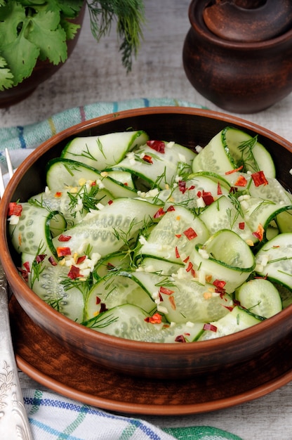 A bowl of salad from cucumber strips with spices garlic and dill Rustic style