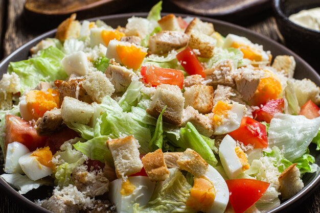 A bowl of salad with croutons and croutons