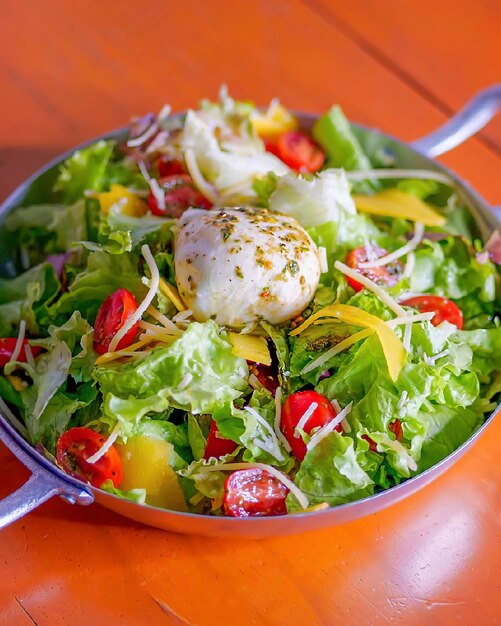 A bowl of salad with a poached egg on top