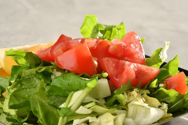 A bowl of salad with tomatoes and cucumbers