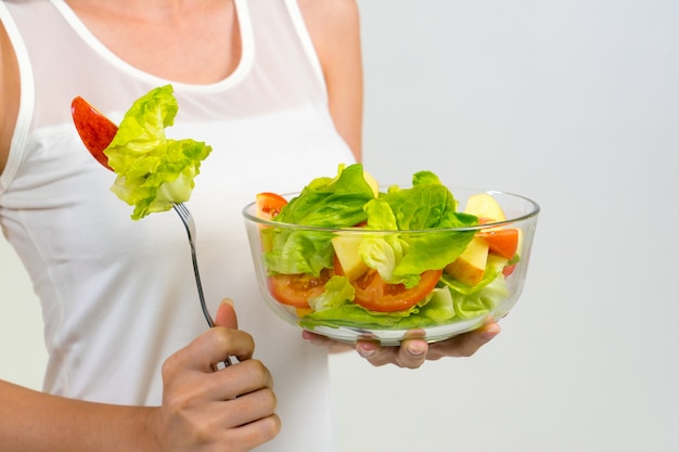 Bowl salad with vegetables and greens on hand