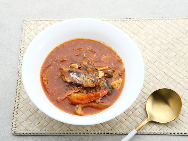 A bowl of sardine served on a white bowl on grey background Selected focus