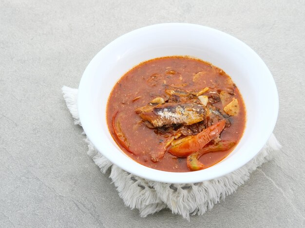 A bowl of sardine served on a white bowl on grey background Selected focus