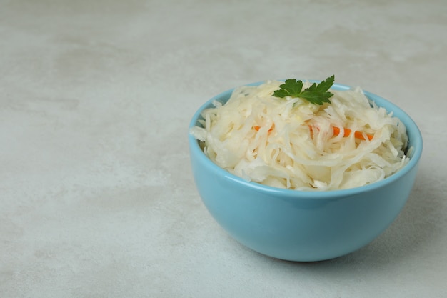 Bowl of sauerkraut on white textured